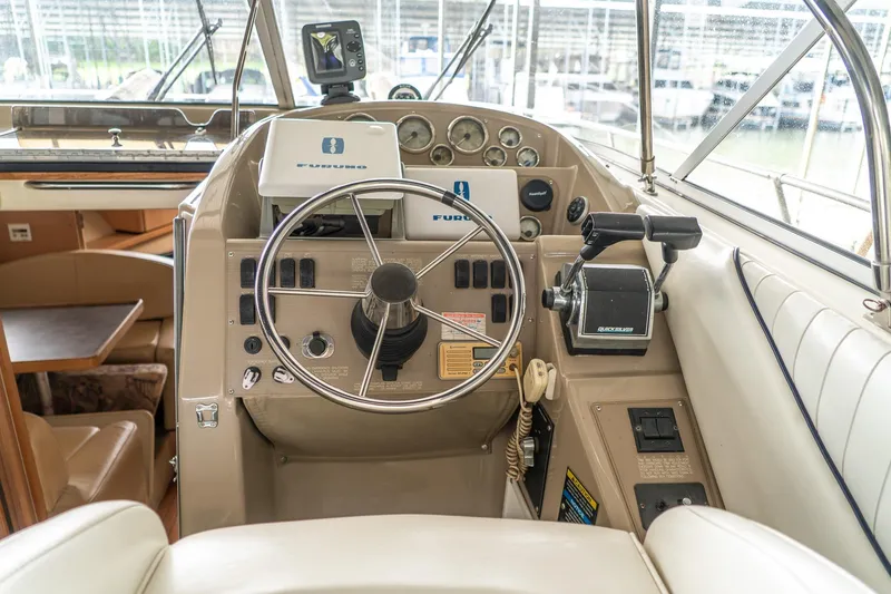 Slide: The Image of Cockpit of 1998 Bayliner 3255 Avanti with steering wheel and navigation controls. - 7