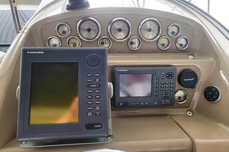 Slide: The Image of 1998 Bayliner 3255 Avanti dashboard with Furuno navigation equipment and multiple gauges. - 8