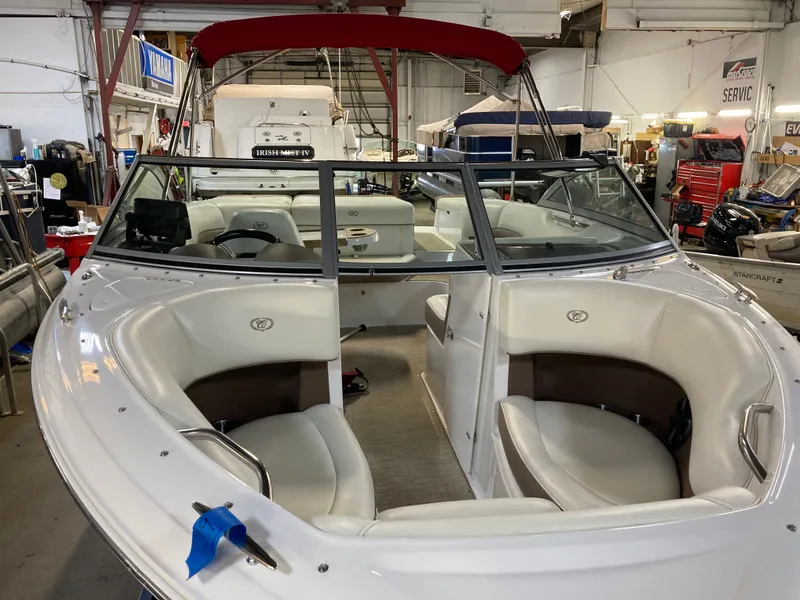 Slide: The Image of 2013 Cobalt 200 boat in a workshop with red canopy. - 12