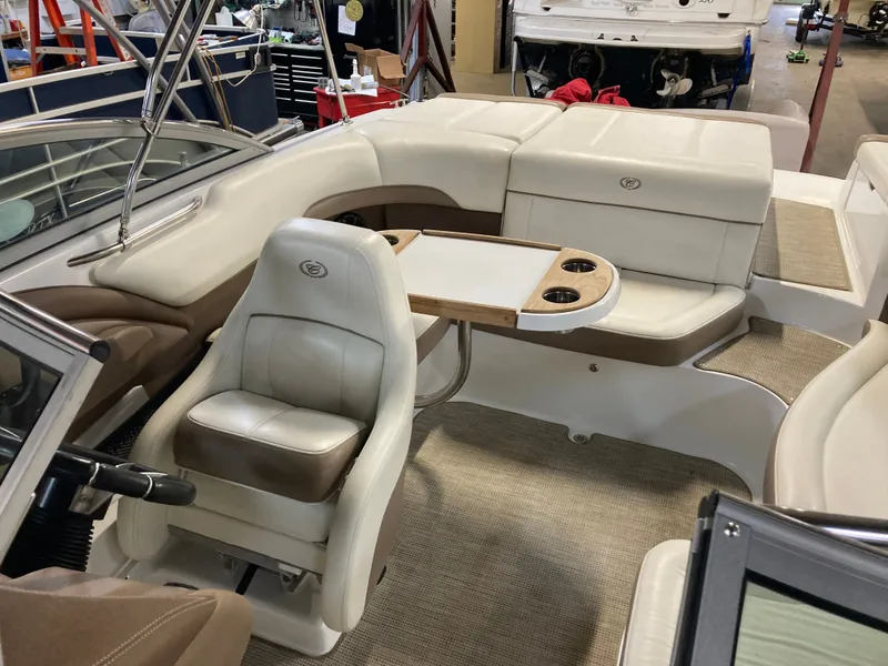 Slide: The Image of Interior of a 2013 Cobalt 200 boat with seating area and table. - 14