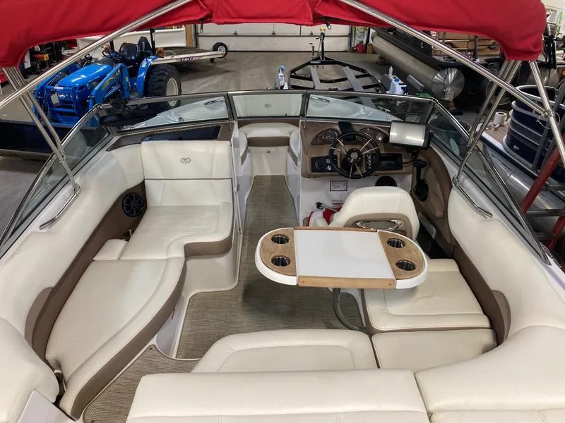 Slide: The Image of Interior of a 2013 Cobalt 200 boat with red canopy. - 18