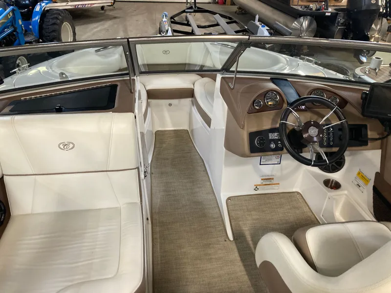 Slide: The Image of Interior of a 2013 Cobalt 200 boat with steering wheel and seats. - 19