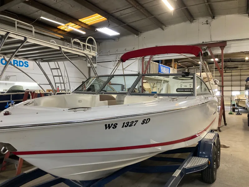 Slide: The Image of 2013 Cobalt 200 boat in warehouse with red canopy. - 2