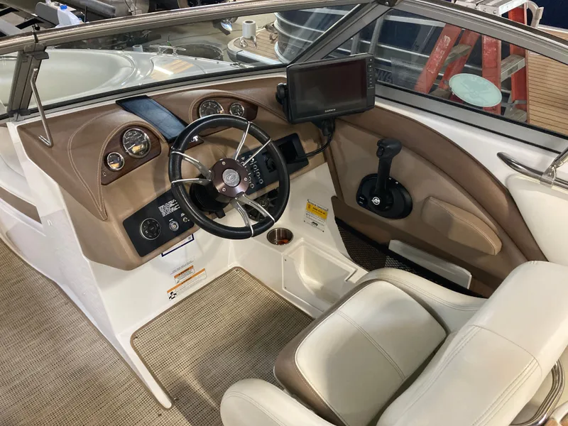 Slide: The Image of Interior of a 2013 Cobalt 200 boat with steering wheel and instruments. - 21