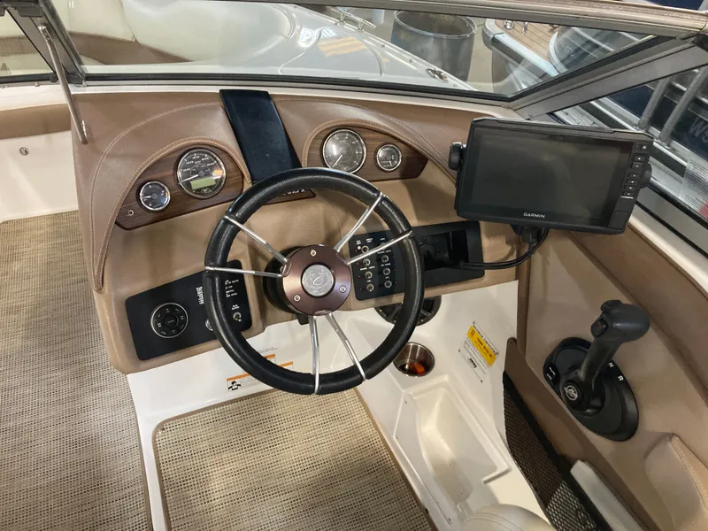 Slide: The Image of Interior of a 2013 Cobalt 200 boat with steering wheel and navigation system. - 22