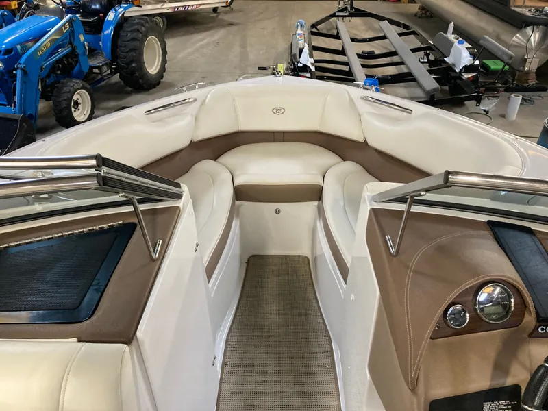 Slide: The Image of Interior of a 2013 Cobalt 200 boat with beige seating. - 23