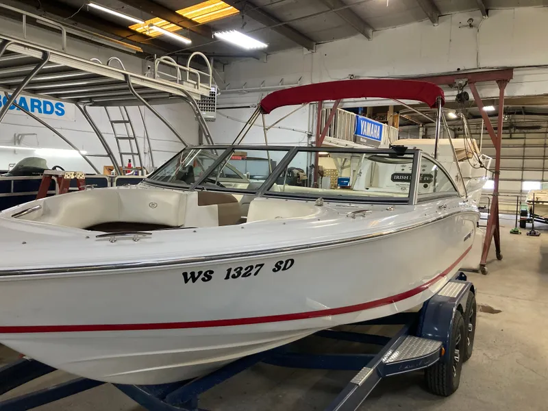Slide: The Image of 2013 Cobalt 200 boat in a workshop on a trailer. - 3