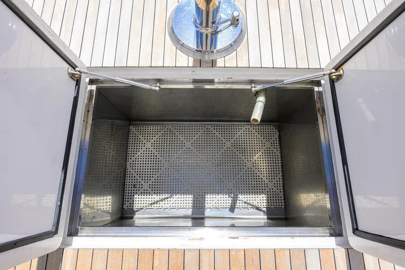 Slide: The Image of Open storage compartment on 2003 American Custom Yachts Sport Fisherman boat deck. - 13