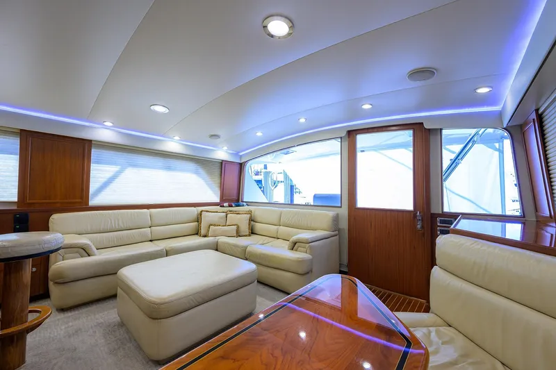 Slide: The Image of Luxurious interior of a 2003 American Custom Yachts Sport Fisherman, featuring plush seating and elegant wood finishes. - 17