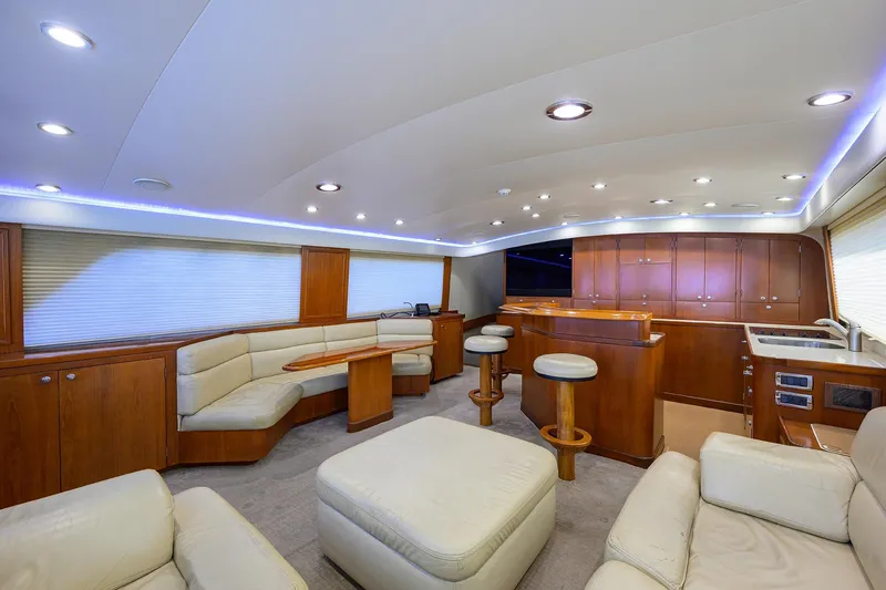 Slide: The Image of Luxurious interior of 2003 American Custom Yachts Sport Fisherman with leather seating and wooden cabinetry. - 19