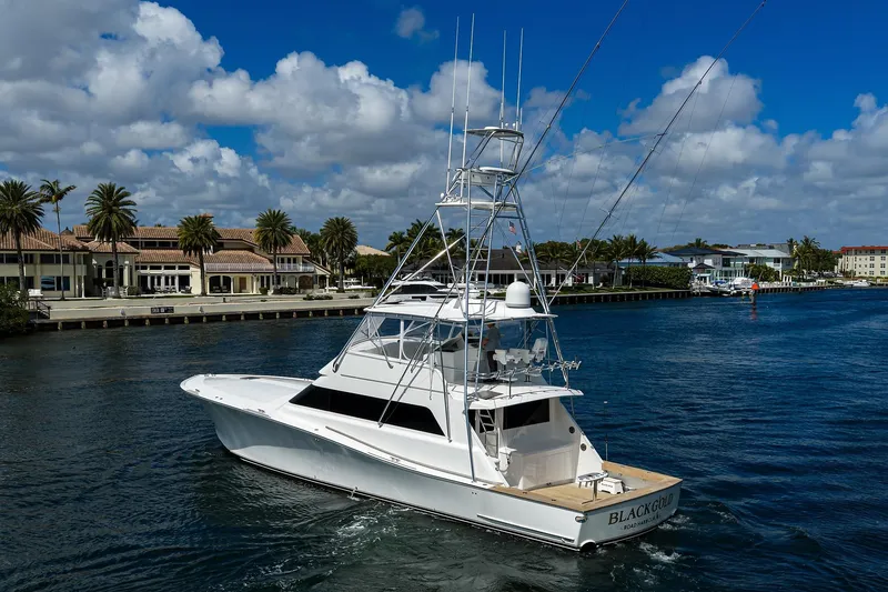 Slide: The Image of 2003 American Custom Yachts Sport Fisherman on scenic waterway, clear skies, palm trees. - 2