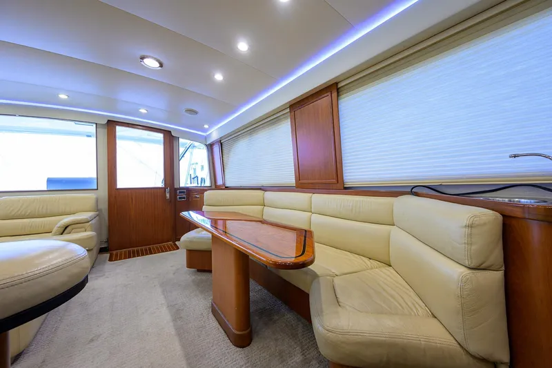 Slide: The Image of Luxurious interior of a 2003 American Custom Yachts Sport Fisherman, featuring plush seating and elegant wood finishes. - 22