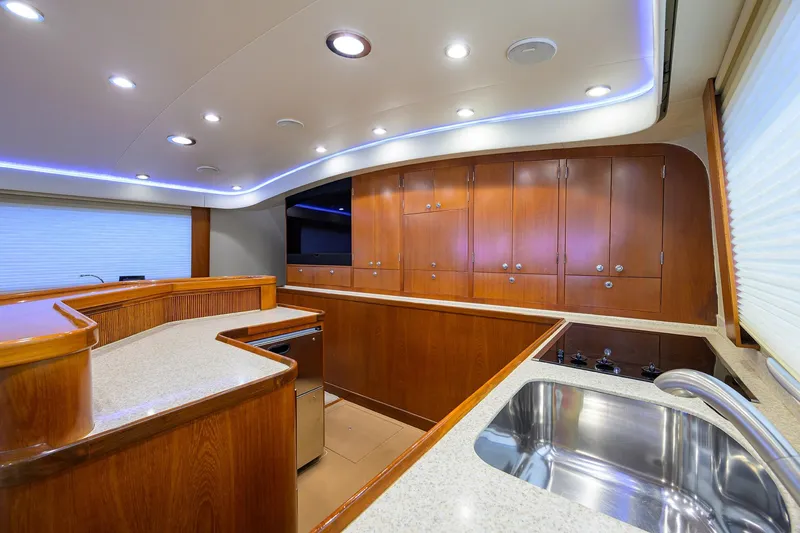 Slide: The Image of Luxurious 2003 American Custom Yachts Sport Fisherman kitchen with wood cabinetry and modern fixtures. - 26