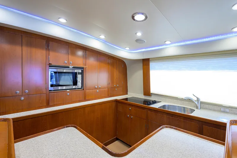 Slide: The Image of Luxurious 2003 American Custom Yachts Sport Fisherman kitchen with modern appliances and wood cabinetry. - 28
