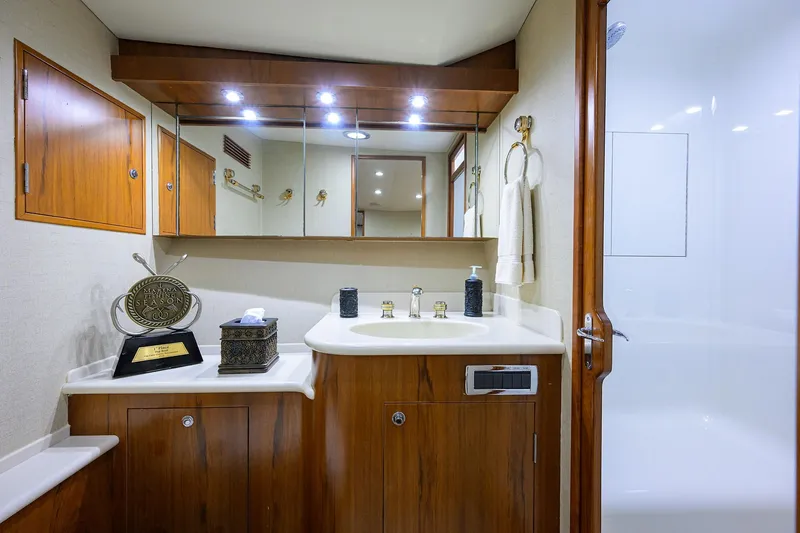 Slide: The Image of Luxurious bathroom in 2003 American Custom Yachts Sport Fisherman, featuring wood cabinetry and modern fixtures. - 29