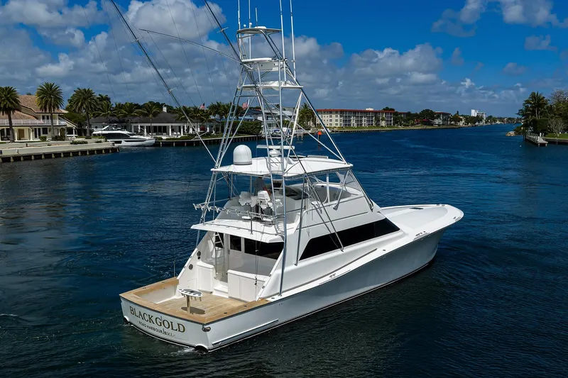 Slide: The Image of 2003 American Custom Yachts Sport Fisherman on a scenic waterway, clear skies above. - 3