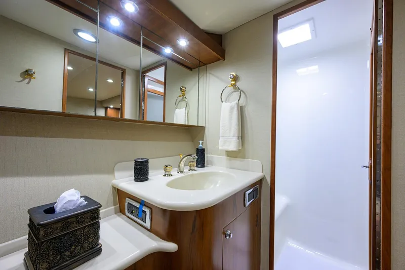 Slide: The Image of Luxurious bathroom in 2003 American Custom Yachts Sport Fisherman, featuring elegant fixtures and lighting. - 30