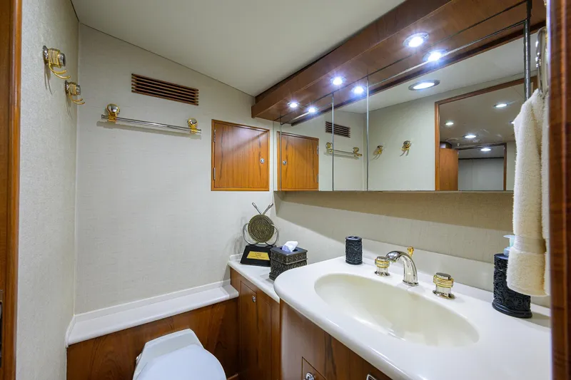Slide: The Image of Luxurious bathroom in 2003 American Custom Yachts Sport Fisherman, featuring elegant fixtures and wood accents. - 31