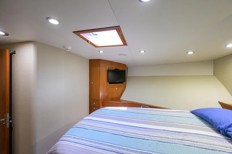 Slide: The Image of Luxurious cabin interior of 2003 American Custom Yachts Sport Fisherman with cozy bed and TV. - 34