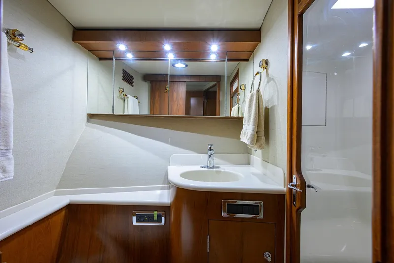 Slide: The Image of Luxurious bathroom in 2003 American Custom Yachts Sport Fisherman, featuring elegant wood and modern fixtures. - 36