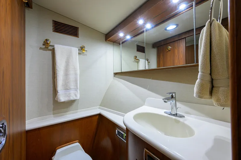 Slide: The Image of Luxurious bathroom in 2003 American Custom Yachts Sport Fisherman, featuring elegant wood and modern fixtures. - 37