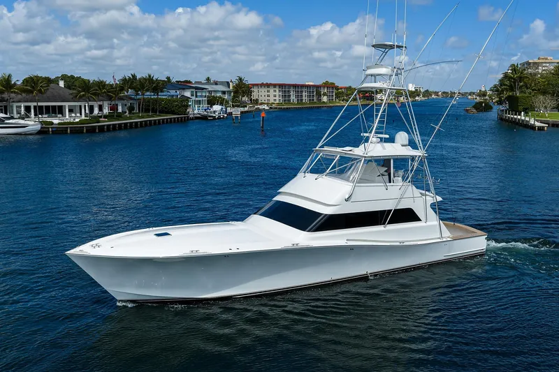 Slide: The Image of 2003 American Custom Yachts Sport Fisherman cruising on a scenic waterway. - 4