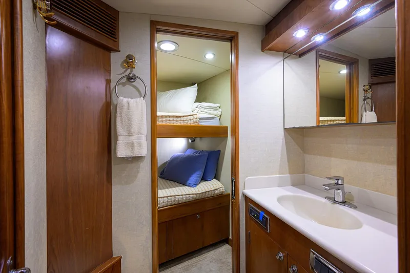 Slide: The Image of Luxurious 2003 American Custom Yachts Sport Fisherman interior with cozy bunk beds and modern bathroom. - 40