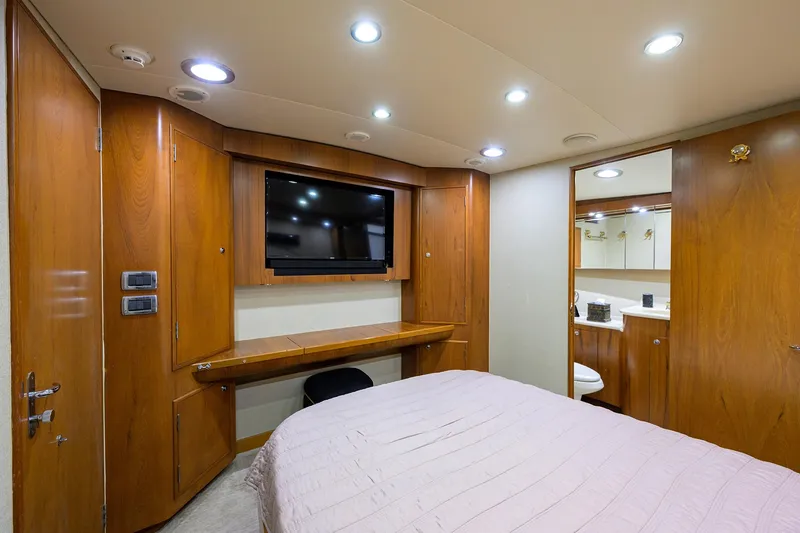 Slide: The Image of Luxurious cabin interior of 2003 American Custom Yachts Sport Fisherman with wood paneling and TV. - 43