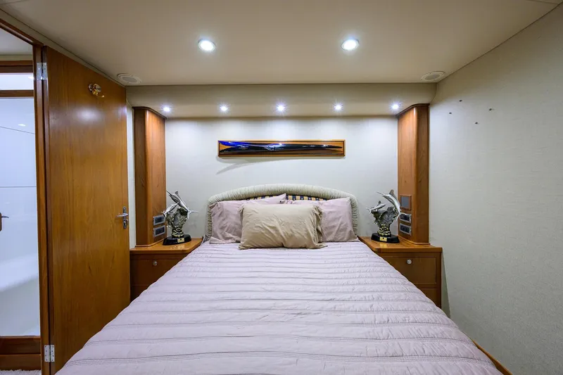 Slide: The Image of Luxurious cabin interior of 2003 American Custom Yachts Sport Fisherman, featuring elegant bedding and decor. - 44