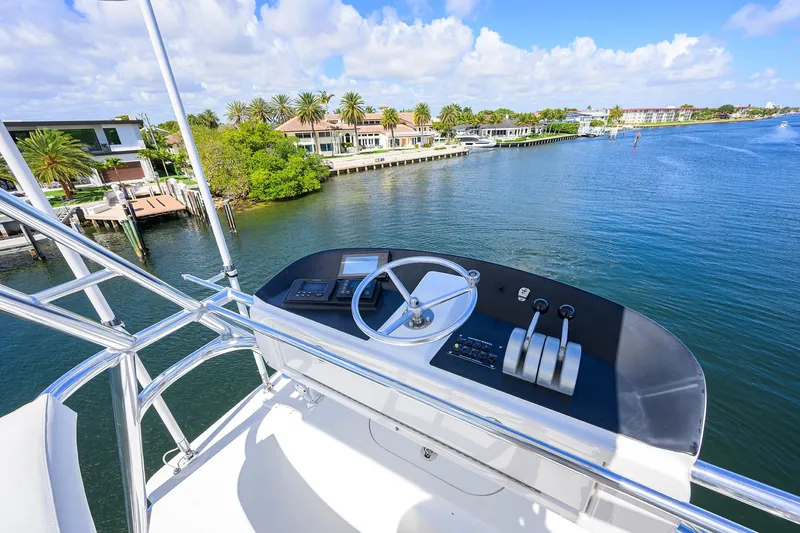 Slide: The Image of Helm view from 2003 American Custom Yachts Sport Fisherman, overlooking serene waterfront homes. - 45