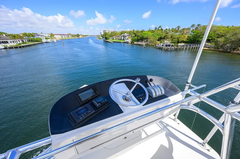 Slide: The Image of Helm of 2003 American Custom Yachts Sport Fisherman overlooking scenic waterway. - 46