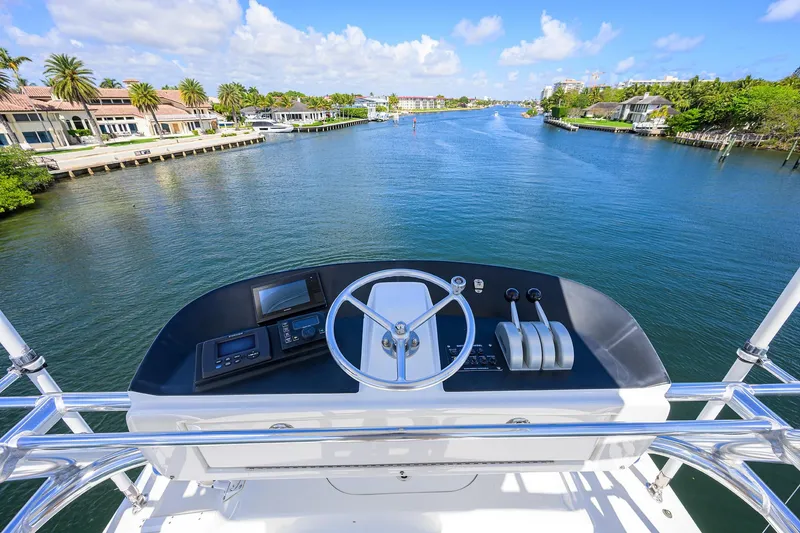 Slide: The Image of Helm view from 2003 American Custom Yachts Sport Fisherman on a scenic waterway. - 47