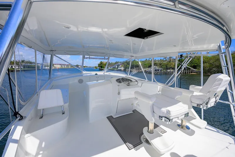 Slide: The Image of 2003 American Custom Yachts Sport Fisherman helm with white seating and panoramic water views. - 49