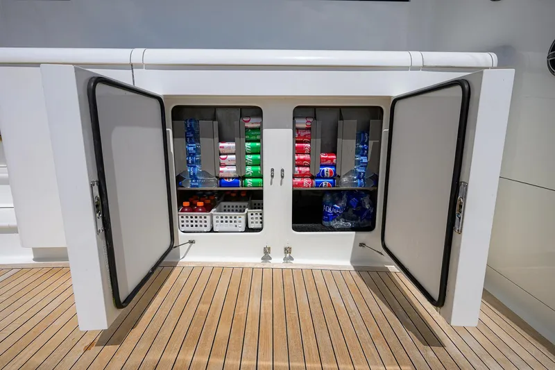 Slide: The Image of Open storage compartment on 2003 American Custom Yachts Sport Fisherman, stocked with beverages and supplies. - 5