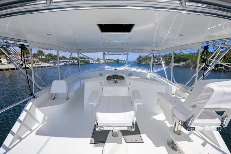 Slide: The Image of 2003 American Custom Yachts Sport Fisherman helm with white seating and panoramic water views. - 50