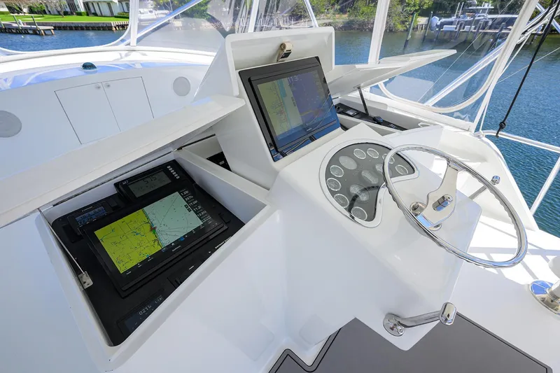 Slide: The Image of Helm of 2003 American Custom Yachts Sport Fisherman with navigation screens and steering wheel. - 55