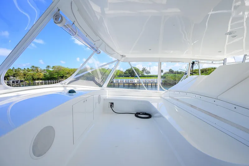 Slide: The Image of 2003 American Custom Yachts Sport Fisherman interior with sleek white design and waterfront view. - 58
