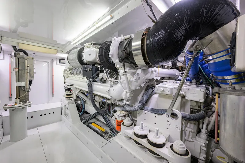 Slide: The Image of Engine room of a 2003 American Custom Yachts Sport Fisherman, showcasing detailed machinery. - 59