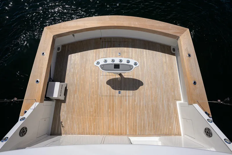 Slide: The Image of 2003 American Custom Yachts Sport Fisherman deck with teak finish, viewed from above. - 6