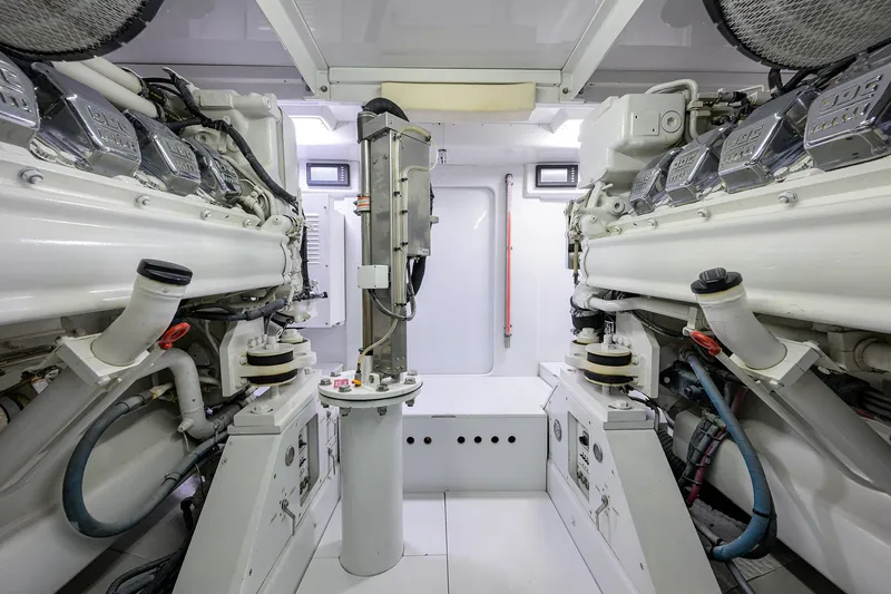 Slide: The Image of Engine room of a 2003 American Custom Yachts Sport Fisherman, showcasing dual engines. - 60