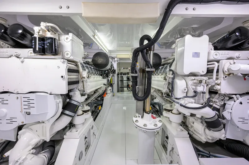 Slide: The Image of Engine room of a 2003 American Custom Yachts Sport Fisherman, showcasing dual engines. - 67