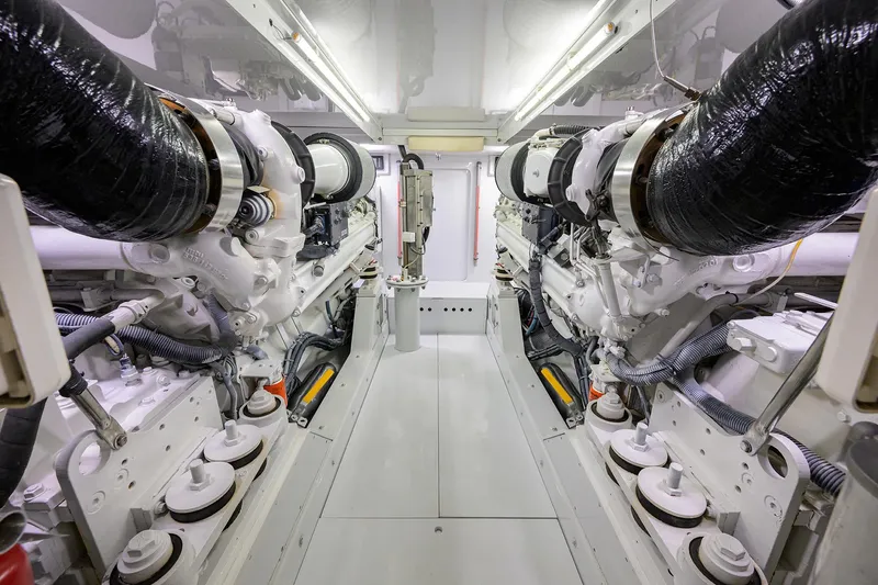 Slide: The Image of Engine room of a 2003 American Custom Yachts Sport Fisherman, showcasing dual engines. - 68