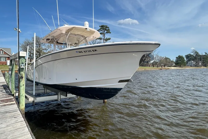 The Image of 2008 Grady-White Canyon 336 boat on lift by dock, scenic waterfront view. - 0