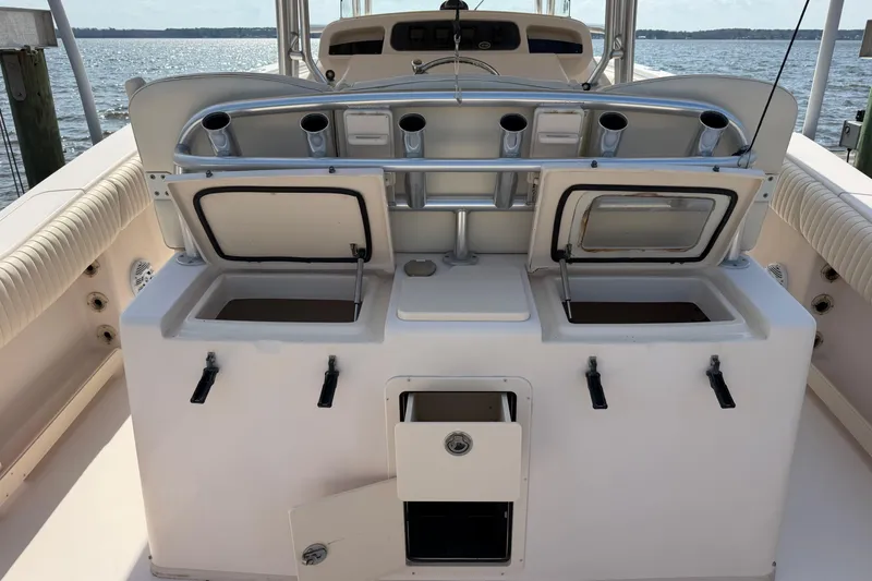Slide: The Image of 2008 Grady-White Canyon 336 boat interior with open storage compartments and rod holders. - 11