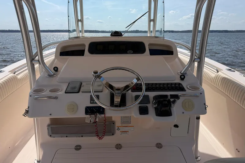 Slide: The Image of 2008 Grady-White Canyon 336 boat helm with steering wheel and controls on open water. - 16