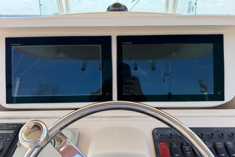 Slide: The Image of Helm of 2008 Grady-White Canyon 336 with dual Furuno displays and steering wheel. - 17
