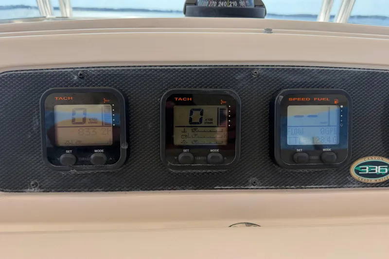 Slide: The Image of Dashboard of a 2008 Grady-White Canyon 336 boat with tachometer and speed fuel gauges. - 18