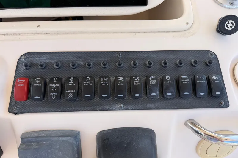 Slide: The Image of Control panel of a 2008 Grady-White Canyon 336 boat with labeled switches. - 21