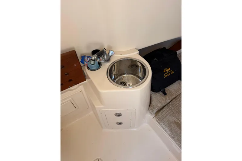 Slide: The Image of 2008 Grady-White Canyon 336 boat interior with sink and storage compartments. - 28
