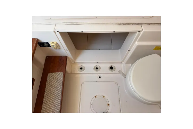 Slide: The Image of 2008 Grady-White Canyon 336 boat interior, featuring storage compartment and seating area. - 31